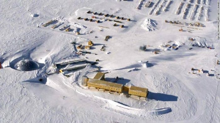 This handout photo dated 31 October 2002 shows an aerial view of the new elevated station (bottom-C) being built at the US Amundsen-Scott South Pole Station in Antarctica. The new station, scheduled to be completed in 2007, is elevated to allow snow to drift underneath and is capable of being jacked up higher as snow accumulates. The new base will replace previous bases already buried under snow, with the original 1957 base about 10 meters (36 feet) under and the current dome base (pictured far L) also becoming buried.   AFP PHOTO/USAF-NATIONAL SCIENCE FOUNDATION/HO (Photo credit should read DAVID MCCARTHY/AFP via Getty Images)