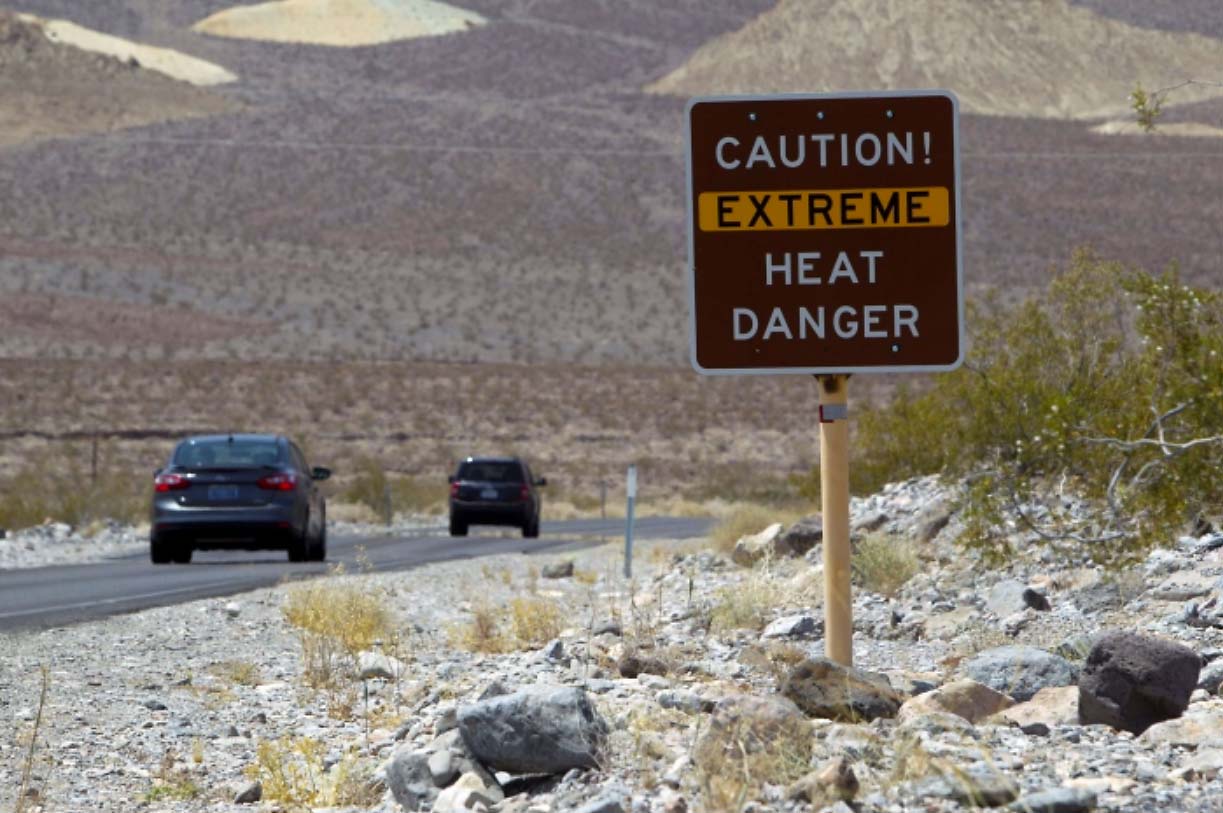 heat-dome-record-breaking-heatwave-death-valley-road-sign-extreme-warning